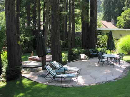 The oval-shaped patio creates an inviting oasis.
